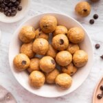Overhead view of a full bowl of peanut butter protein balls ready for snacking.