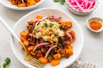 Roasted sweet potatoes topped with ground beef, street corn salsa, pickled red onions, cilantro and hot honey.