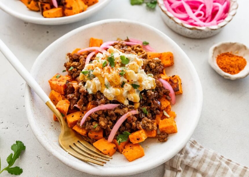 Roasted sweet potatoes topped with ground beef, street corn salsa, pickled red onions, cilantro and hot honey.
